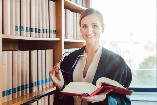 Lawyer working on a difficult case reading in the library of law firm